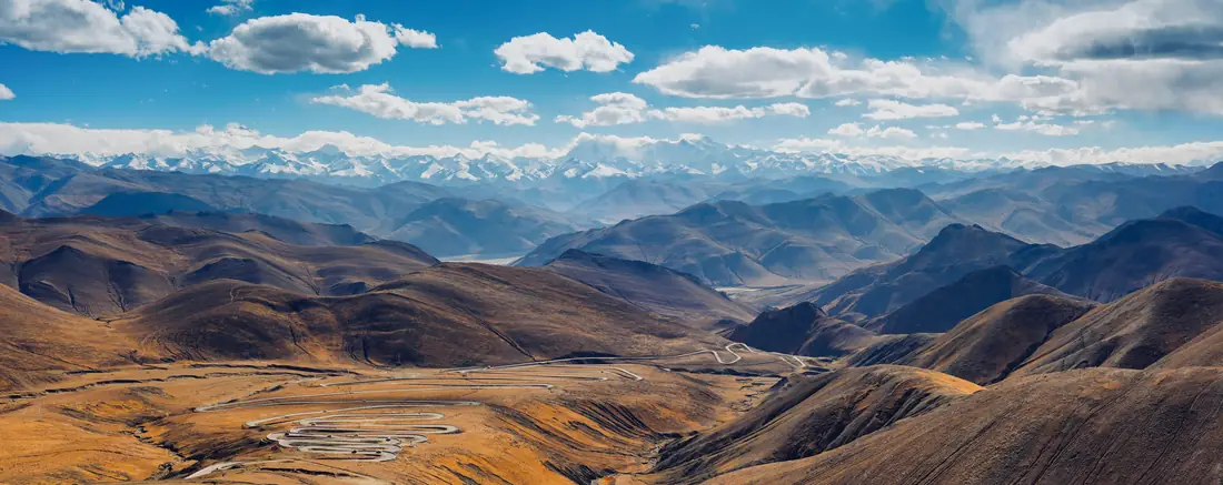 The Himalayas rising behind a mountain highway